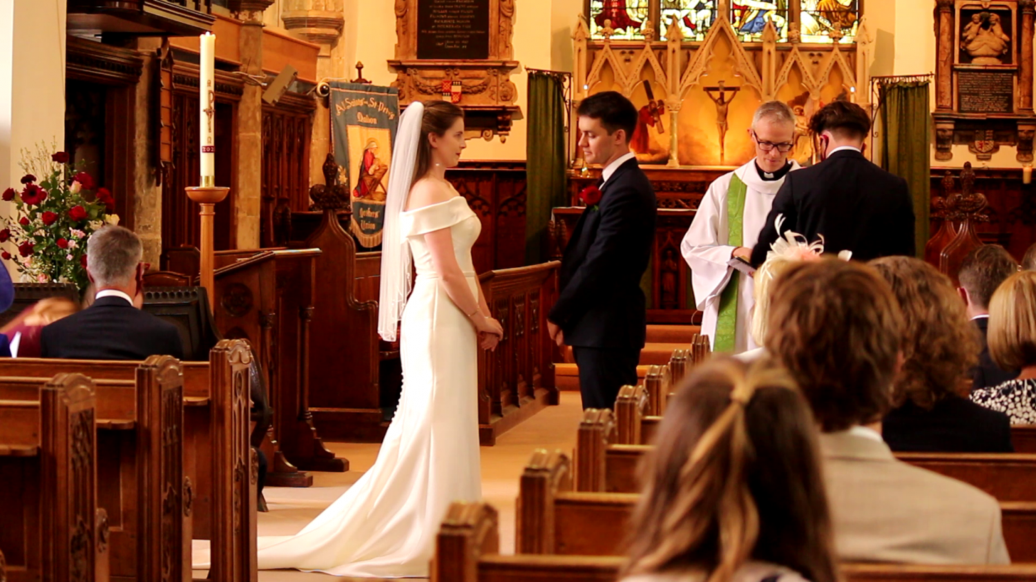 Bride and groom standing in church doorway